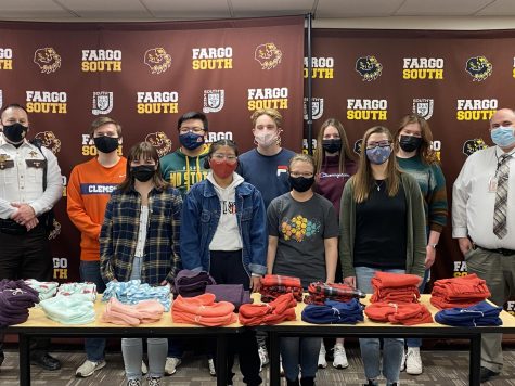 A picture of PaY members and Cass County recipients. 
Back row left to right: Sheriff Jahner, Blake Sorby, Tommy Do, Aiden Bourke, Alivia Abel, Emma Rudolph, Andy from Cass County.
Front row left to right: Adeline Raum, Guadalupe Marino, Gabrielle McGarvey, Darby Human. 
