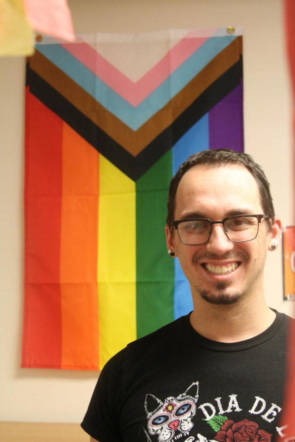 Mr. Taragos poses in front of a pride flag. He ran Spectrum, South's LGBTQ+ club, for the first time this year.